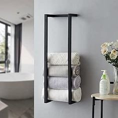 a bathroom with a sink, mirror and towel rack