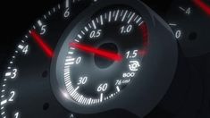 the speedometer on a car is showing red and white lights in the dash light