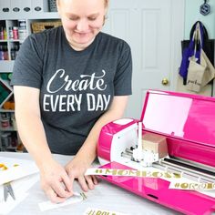 a woman is working on a project in her craft room while wearing a t - shirt that says create every day