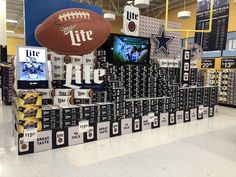 a football display in a store filled with boxes and signs that say it's time to hit the football