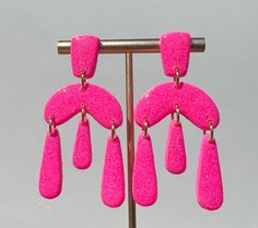 Gorgeous lightweight earrings that are fun to wear and go with any outfit. Trendy Pink Drop Chandelier Earrings, Trendy Pink Glitter Earrings, Novelty Pink Hypoallergenic Earrings, Hot Pink Polymer Clay Earrings, Pink Novelty Earrings, Vibrant Pink Handmade Earrings, Playful Pink Plastic Earrings, Lightweight Earrings, Light Weight Earrings