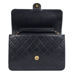 Authentic, pre-loved black lambskin leather Chanel classic single flap snap closure bag. Features front flap closure with CC snap closure, lambskin leather, large interior with zipper slip pocket, long gold weaved leather chain, 24 kt gold plated hardware. This is a very rare vintage Chanel that you will just love. Strap drop: 16" Authenticity hologram stamp and the card read: 5880966 Made in Italy 1997-1999 24kt Gold, Vintage Chanel, Leather Chain, Lambskin Leather, Very Rare, Chanel Classic, Snap Closure, Leather Shoulder Bag, Gold Plate