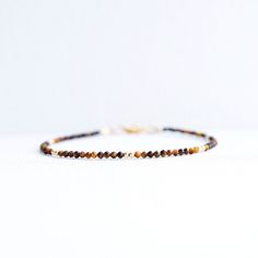 Tiger's Eye Bracelet  Finished with a lobster clasp. *BRACELET LENGHT- 6.0, 6.5, 7.0, 7.5, 8.0 Inches* * MATERIALS & DIMENSIONS * * Tiger Eye Beads: about 2 mm - Grade AAA * Gold Filled or Sterling Silver Beads: about 2.0 mm * Gold Filled or Sterling Silver Findings * Premium Strong Flexible Beading Wire *Arrives in a gift box* Choose Your Bracelet Length Use a tape measure. Wrap the tape measure around the wrist on which you plan to wear your bracelet. Make a note of the number at the point whe Tigers Bracelet, Tiger Bracelet Gold, Tiger's Eye Bracelet, Tigers Eye Crystal Bracelet, Tiger Eye Bracelet, Tiger Eye Beads, Beading Wire, Healing Bracelets, How To Make Notes