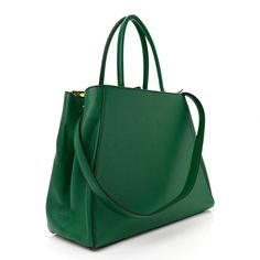 This is an authentic FENDI Vitello Elite Regular 2Jours Tote in Emerald. This stylish tote is crafted of luxurious fine textured leather in green and features thin rolled leather strap top handles, an optional leather shoulder strap and expansive sides. This opens to a partitioned fabric interior with pockets. Strap Top, Strap Tops, Flamingo, Leather Straps, Emerald, Fendi, Shoulder Strap, Handles, Green