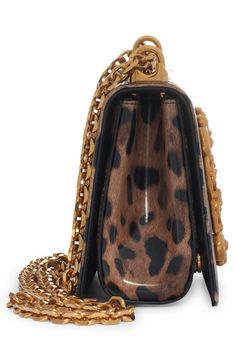 A baroque-inspired D&G logo adds to the glamour of this leopard-print leather bag featuring a pull-through strap that allows for crossbody or shoulder wear. Magnetic-snap flap closure Pull-through chain strap Leather lining Leather Made in Italy Designer Handbags Evening Shoulder Bag In Leopard Print With Detachable Strap, Leopard Print Leather Bag With Gold-tone Hardware, Designer Leather Bags In Leopard Print, Leopard Print Shoulder Bag With Detachable Strap For Evening, Evening Leopard Print Shoulder Bag With Detachable Strap, Luxury Leather Bags In Leopard Print, Luxury Crossbody Bags With Brass Hardware, Luxury Leopard Print Leather Bag, Luxury Leather Shoulder Bag In Leopard Print