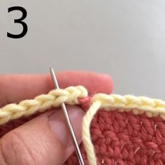 someone is crocheting the stitchs together with their fingers