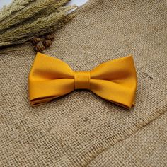 "We proudly present our solid marigold tie collection. -Hand-sewn semi skinny Adult Neck Tie -Pre-tied Bow tie available from Newborn up-to Adult size with adjustable strap. (Bow tie stitched into place) -Pocket square. Material: 100% Wool interlining Measurements: The necktie is 54\" or 137cm in length The widest part measures 2 3/4\" or 7 cm Pocket square measure approximately 10\" squares. Our experienced team has over 100 years worth of professional sewing experience combined. Our items are Dapper Gold Accessories For Black Tie Suit, Dapper Gold Bow Tie For Formal Occasions, Gold Dapper Bow Tie For Formal Occasions, Classic Gold Bow For Black Tie Events, Classic Gold Suit And Tie Accessories With Satin Bow, Gold Suit And Tie Accessories For Wedding, Classic Gold Suit Accessories With Satin Bow, Gold Bow Ties For Black Tie Events, Gold Bow Tie For Formal Occasions