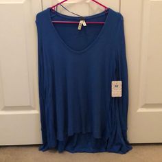 Free People Long Sleeve Blue Thermal Tee. Slight High/Low Hem, Wide U-Neck Line And Thumb Hole Detail. Casual Blue T-shirt For Layering, Blue T-shirt For Summer Layering, Blue Casual Long Sleeve Top For Fall, Casual Blue Long Sleeve Top For Fall, Light Blue V-neck Top For Fall, Casual Long Sleeve Top For Summer Loungewear, Casual Blue Long Sleeve Top, Blue Relaxed Fit Long Sleeve Top For Spring, Casual Blue Crew Neck Long Sleeve Top