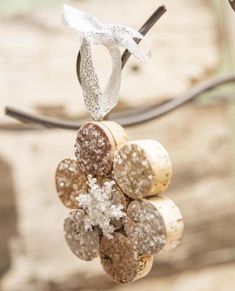 a bunch of wine corks are hanging from a string with snow flakes on them