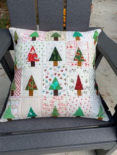 a pillow sitting on top of a gray chair