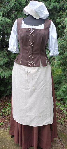 Historical costum or fantasy costum for woman. Under shirt made from White cotton fabric.the blouse is tied at the neck with a cord Round Skirt is made from cotton Fabric. There is a rubberband and cord at the waist. Stays is made from woolen Fabric. Lining is made from white cotton Fabric. the costume also includes a linen apron and a cotton cap. Also costume includes: - shirt - stays - skirt - bonnet - apron This dress will be made to measure. IF YOU PREFER A DIFFERENT COLOR CONTACT ME Please Huterite Dress, Historical Victorian Dress For Larp, Peasant Style Medieval Linen Dress For Larp, Peasant Style Linen Medieval Dress For Larp, Fitted Prairie Dress Costume For Medieval Festivals, Medieval Prairie Dress For Costume, Fitted Linen Medieval Dress, Victorian Dress For Larp And Medieval Festivals, Fitted Prairie Dress For Larp And Medieval Festivals