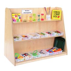 the children's book shelf has many different items on it, including pens and pencils