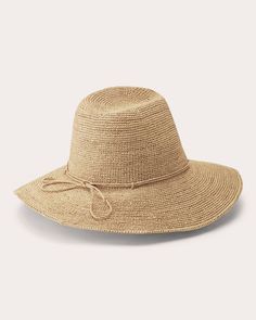 Woven from natural raffia, the Desmonda hat shapes its neutral-hued silhouette with a hand-rolled raffia tie and adjustable inner band. The wavy brim and indented crown give nod to traditional fedora styles. Adjustable inner band Hand-rolled raffia tie Indented crown Wavy brim Goldtone seed logo 100% Madagascan raffia Spot clean Made in Sri Lanka Measurements Brim: 3.14in Crown: 4in Natural Woven Curved Brim Hat, Luxury Handwoven Natural Fedora, Eco-friendly Beige Straw Hat With Curved Brim, Eco-friendly Natural Woven Straw Hat, Eco-friendly Woven Straw Hat With Curved Brim, Sri Lanka, Fedora, Gold Tones