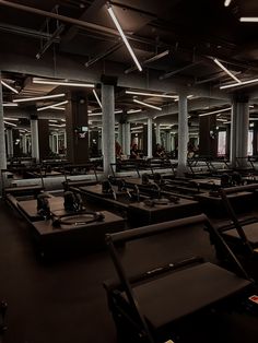 rows of black beds in an empty room