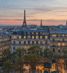 the eiffel tower is lit up at night in this cityscape photo