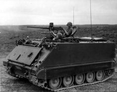 an army tank with two men in it