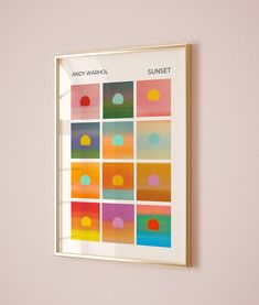 an art piece hanging on the wall next to a window with different colored squares in it