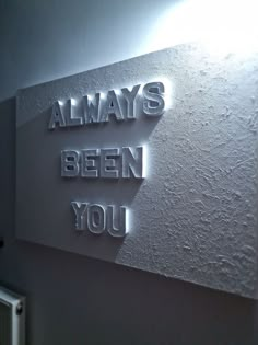 there is a sign that says always been you on the side of a wall in a room