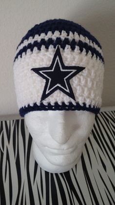 a crocheted hat with a star on the front and black and white stripes