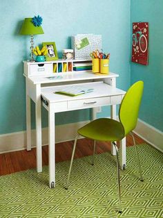 there is a small white desk and yellow chair in this child's playroom