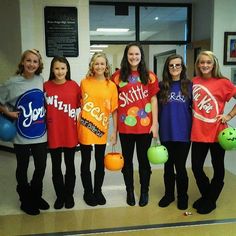 a group of women standing next to each other holding bowling balls and wearing t - shirts that say skittle