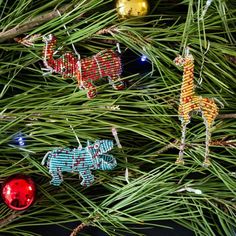 some ornaments are hanging from a pine tree