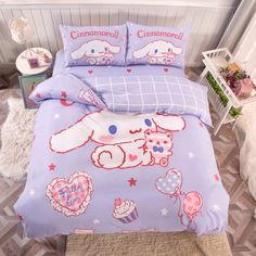 a bed with pink and blue comforters on it