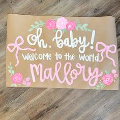 a welcome mat with pink flowers and the words, oh baby welcome to the world malory