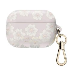 an airpods case with flowers on it and a keychain attached to it