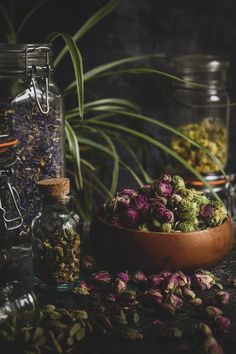 various herbs and spices in glass jars on a table