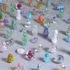 many different colored glass bottles on a table