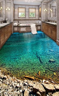 a large bathroom with blue water in the floor and rocks on the ground around it