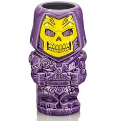 a purple and yellow ceramic vase with a skull face on it's front end