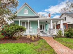 a blue house with white trim and porch