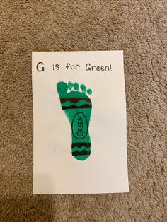 a paper with a green foot print on it that says g is for green handprint