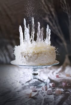 a cake with icing on it sitting on top of a table