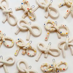 the letters are made out of white plastic and decorated with confetti, scissors and pins