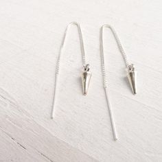 These delicate, but edgy earrings feature sterling silver threads which dangle in the front and back when worn. They have sterling silver spikes on the ends. . { s h i p p i n g } . Other threader style earrings: https://www.etsy.com/shop/CamileeDesigns/search?search_query=threader . { p a c k a g i n g } . Your jewelry will arrive in a cute box - perfect for giving or keeping for yourself. . { s h i p p i n g } . Handmade in my studio and shipped via USPS mail with tracking. Please see shipping Spike Jewelry, Spiked Jewelry, Ear Threader, Silver Threader Earrings, Edgy Earrings, Thread Earrings, Cute Box, Threader Earrings, Gift For Friend