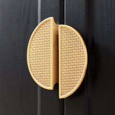 a close up of a door handle on a wooden door with black woodgrain