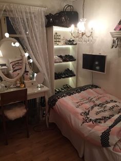 a bedroom with a bed, desk and shelves filled with shoes on top of it