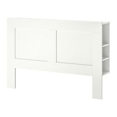 a white headboard with two open shelves on each side and one closed drawer at the top