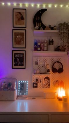 a desk with some lights and pictures on the wall