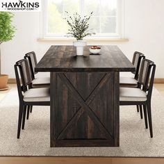 a dining room table with chairs and a potted plant in the corner on top