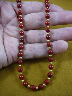 (Internal #V-30-7)  You are bidding on a beautiful, handmade, necklace made, round red bamboo coral 6 mm with gold plated spacer beads. Necklace is 16" long, with gold safety closure.* Want something larger, special order is $2.50 per inch.WE SHIP WORLDWIDE! Other accepted payment: Credit card (Mastercard/Visa/Discover) inquire for details. Red Coral Beaded Necklaces With Spacer Beads, Red Coral Spacer Beads, Round Shape, Red Coral Spacer Beads, Red Coral Round Spacer Beads, Gold Beaded Necklaces With Red Coral Round Beads, Red Coral Jewelry With Gold Beads, Gold Beaded Necklace With Polished Red Coral, Red Coral Necklace With Gold Beads For Gift, Red Gemstone Beaded Necklaces For Festivals