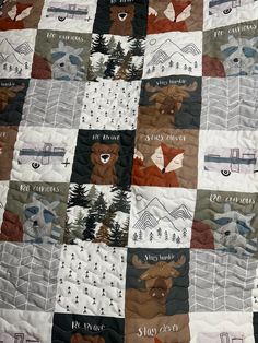 the quilt is made up to look like it has animals and trees on it in different colors