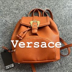 Very Beautiful Mini Backpack Mustard Color Luxury Backpack With Logo Hardware For Everyday Use, Luxury Backpack For Everyday Use With Logo Hardware, Luxury Leather Backpack With Branded Hardware, Luxury Leather Shopping Backpack, Luxury Leather Backpack For Shopping, Luxury Backpack With Adjustable Strap For Errands, Designer Backpack With Gold-tone Hardware, Luxury Brown Backpack With Branded Hardware, Versace Handbags