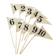 four white flags with numbers on them sitting in front of a white background and one is black