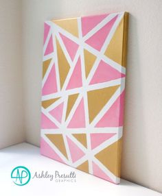 a pink and gold painting on a white wall