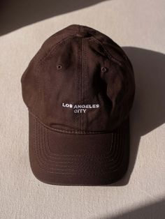 SOFT CANVAS DAD HAT FEATURES CREAM "LOS ANGELES CITY" EMBROIDERY UNSTRUCTURED FIT WITH ADJUSTABLE STRAP Brown Baseball Cap With Embroidered Logo, Brown Dad Hat, One Size, Everyday, Brown Embroidered Baseball Cap With Curved Brim, Brown Dad Hat For Everyday Use, Brown Dad Hat For Everyday Wear, Brown Embroidered Curved Brim Baseball Cap, Brown Dad Hat With Letter Print, Brown Dad Cap With Letter Print, Brown Embroidered Baseball Cap