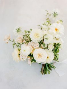 a bouquet of white flowers sitting on top of a table